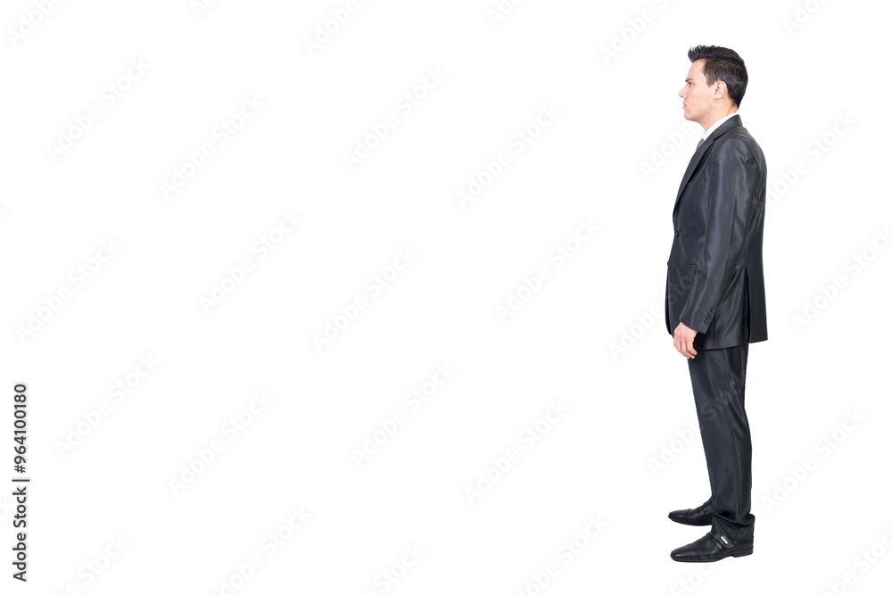 Serious male manager in suit standing in white studio Serious male manager in suit standing in white studio