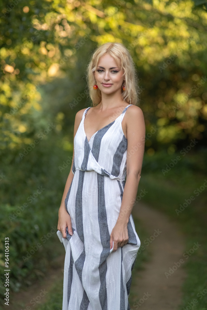 Portrait of a young beautiful blonde girl in a summer forest. Portrait of a young beautiful blonde girl in a summer forest.