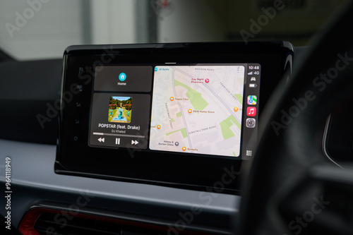 Apple Maps light mode on CarPlay screen with music controls