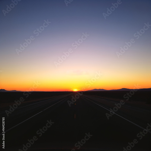 Open road at sunrise in a vast desert landscape