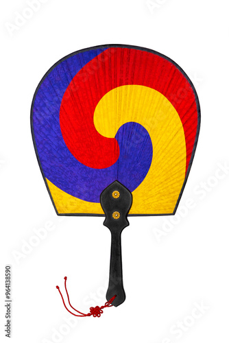 Korean traditional fan with wooden handle and silk fabric in three colors - red, yellow and blue isolated on white background. Buddhist Yin-Yang symbol