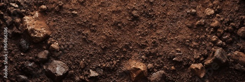 A Close Up View of Rich, Dark Soil Displaying Its Unique Texture and Diverse Pebbles Beneath