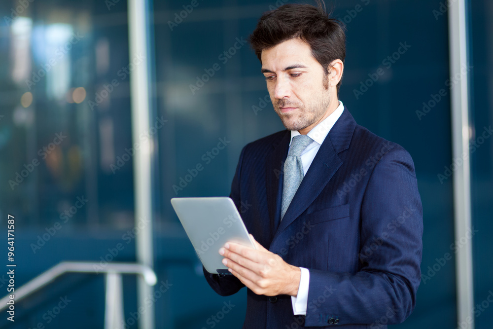 Professional businessman using tablet outdoors Professional businessman using tablet outdoors