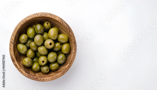 Wooden bowl with green olives on white background photo