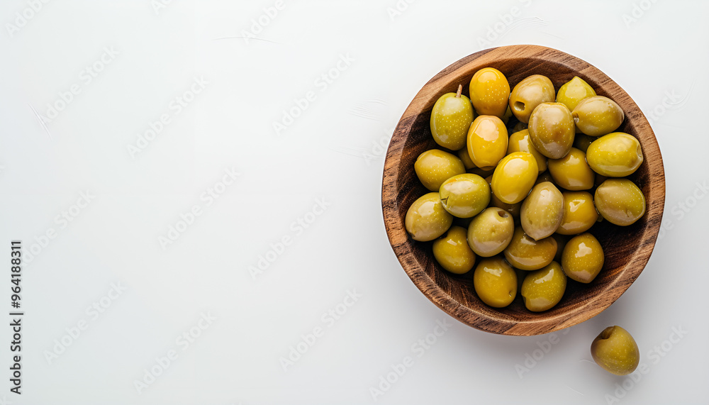 Wooden bowl with green olives on white background Wooden bowl with green olives on white background