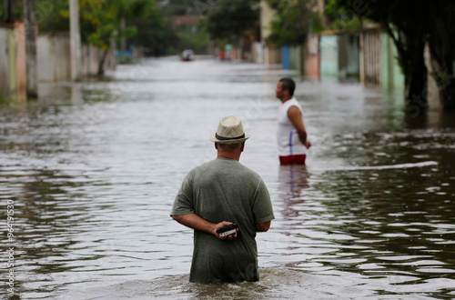 People walk along a flooded street after heavy rains in Espirito Santo state, Brazil.