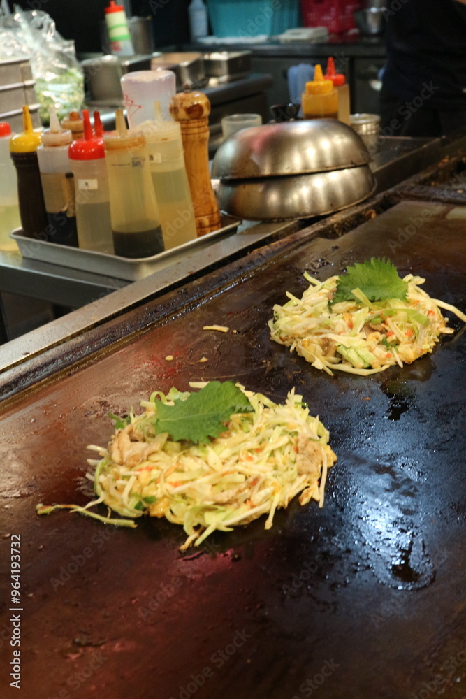 Okonomiyaki, JapanesePancake, SavoryPancake, JapaneseCuisine, StreetFood, Teppanyaki, JapaneseComfortFood, TraditionalJapaneseFood, GrilledDish, CabbagePancake, AsianCuisine, CustomizableDish, Japanes