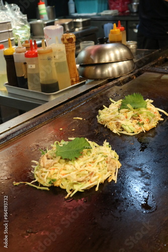 Obraz na płótnie Okonomiyaki, JapanesePancake, SavoryPancake, JapaneseCuisine, StreetFood, Teppanyaki, JapaneseComfortFood, TraditionalJapaneseFood, GrilledDish, CabbagePancake, AsianCuisine, CustomizableDish, Japanes w salonie
