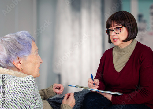 Ensuring final wishes: Notary carefully documents elderly woman's animated instructions during important home consultation.