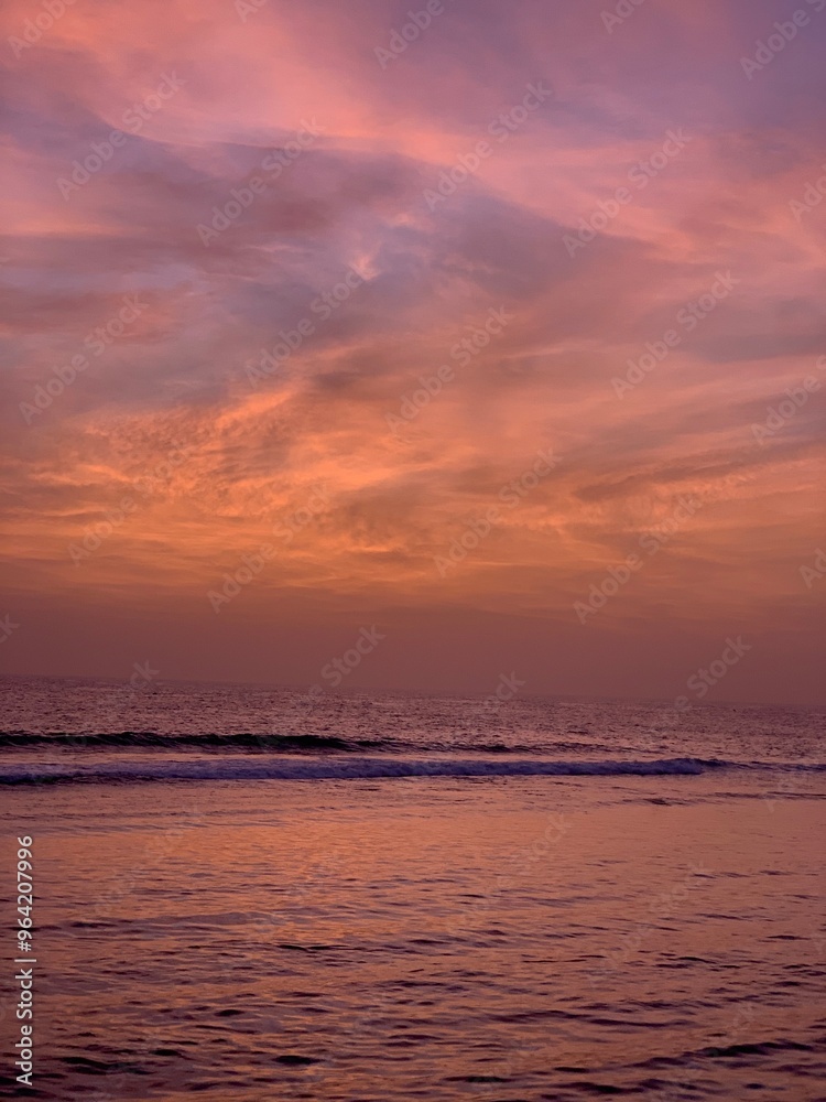 A beautiful sunset on a beach in the Red Sea of Saudi Arabia, with warm colors in the sky like red, orange, and yellow. The waves of the sea shimmer under the setting sun A beautiful sunset on a beach in the Red Sea of Saudi Arabia, with warm colors in the sky like red, orange, and yellow. The waves of the sea shimmer under the setting sun