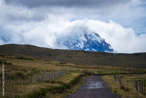 The snow-capped volcano Antisana located between the provinces of PIchincha and Napo in Ecuador with blue sky and white clouds. Landscape in Ecuador 