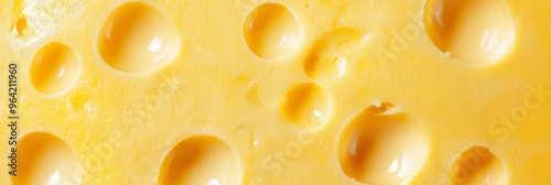 Texture of yellow cheese with large holes close up. Detailed photo of cheese surface in macro