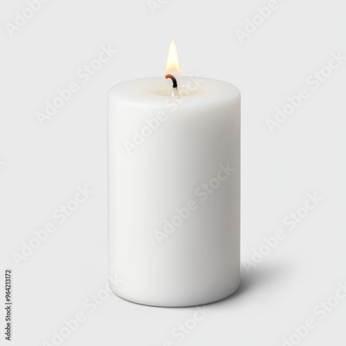 A white candle with a wick is lit