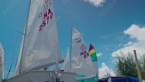 Mainsail and jib or headsail of a sailboat blowing in the wind with the sun in the background photo