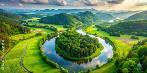 Aerial View Of A Tranquil River Meandering Through A Lush Green Valley, Creating A Serene And Picturesque Landscape. photo