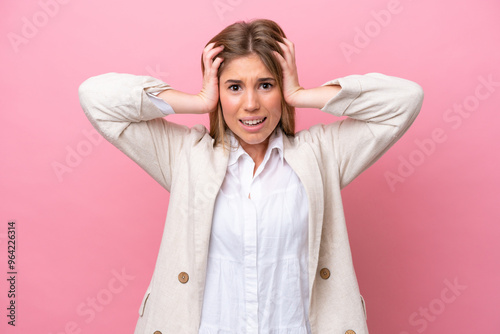 Young caucasian woman isolated on pink bakcground doing nervous gesture