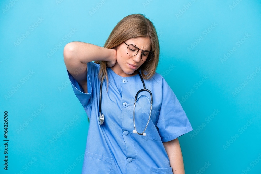 Young surgeon doctor woman isolated on blue background with neckache Young surgeon doctor woman isolated on blue background with neckache