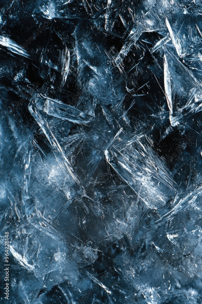 A blue and white image of ice with a lot of cracks and splinters. The image has a cold and desolate feeling to it A blue and white image of ice with a lot of cracks and splinters. The image has a cold and desolate feeling to it