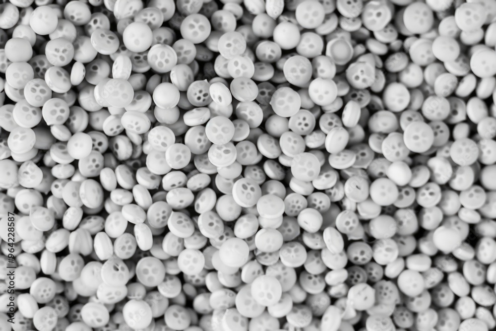 A pile of white buttons with holes in them. The buttons are scattered all over the image. The image has a somewhat eerie and unsettling mood A pile of white buttons with holes in them. The buttons are scattered all over the image. The image has a somewhat eerie and unsettling mood