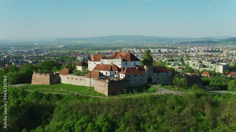 Drone shot of Brasov Citadel at sunset, daylight, sunny day Drone shot of Brasov Citadel at sunset, daylight, sunny day