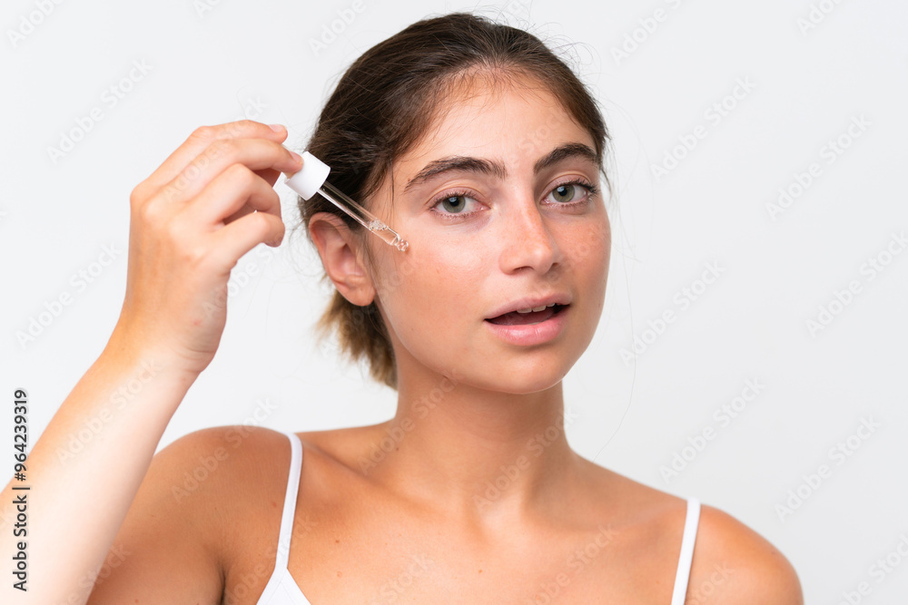 Young Pretty caucasian woman isolated on white background holding a serum. Close up portrait Young Pretty caucasian woman isolated on white background holding a serum. Close up portrait