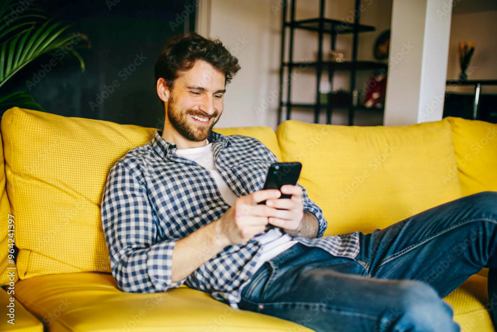 Man Relaxing on Vibrant Yellow Couch in Modern Living Room Interior Man Relaxing on Vibrant Yellow Couch in Modern Living Room Interior