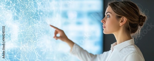 Employee pointing to a complex diagram on a large interactive screen, collaborative problemsolving in a corporate setting
