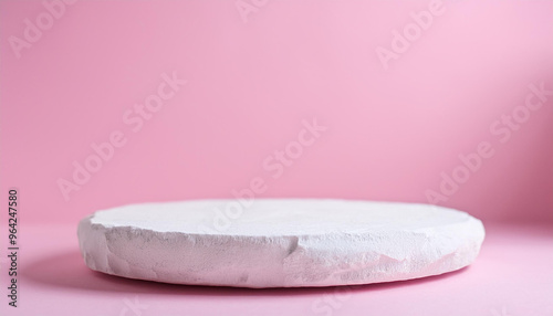 Empty round podium for product presentation, minimal pedestal. Light pink backdrop.