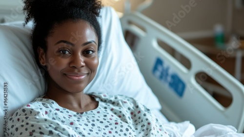 Smiling Black woman resting in hospital bed after medical treatment