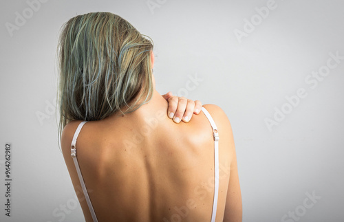 Quadro su tela Woman suffering from nape pain using hand to massage