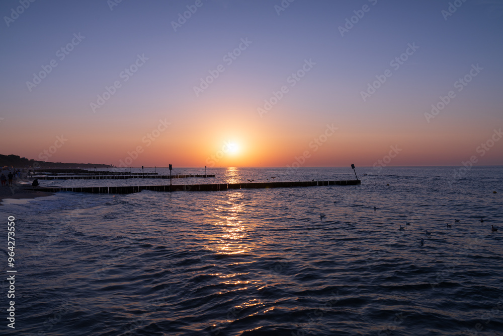 Serene sunset at the shoreline in Kolobrzeg, Kołobrzeg Serene sunset at the shoreline in Kolobrzeg, Kołobrzeg