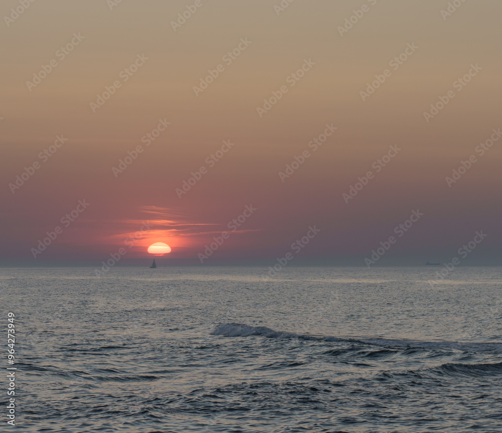 Fototapeta premium Serene sunset at the shoreline in Kolobrzeg, Kołobrzeg