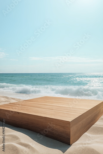 Wooden rectangular podium on sandy beach with ocean waves and clear blue sky in backdrop. Product display background with copy space.