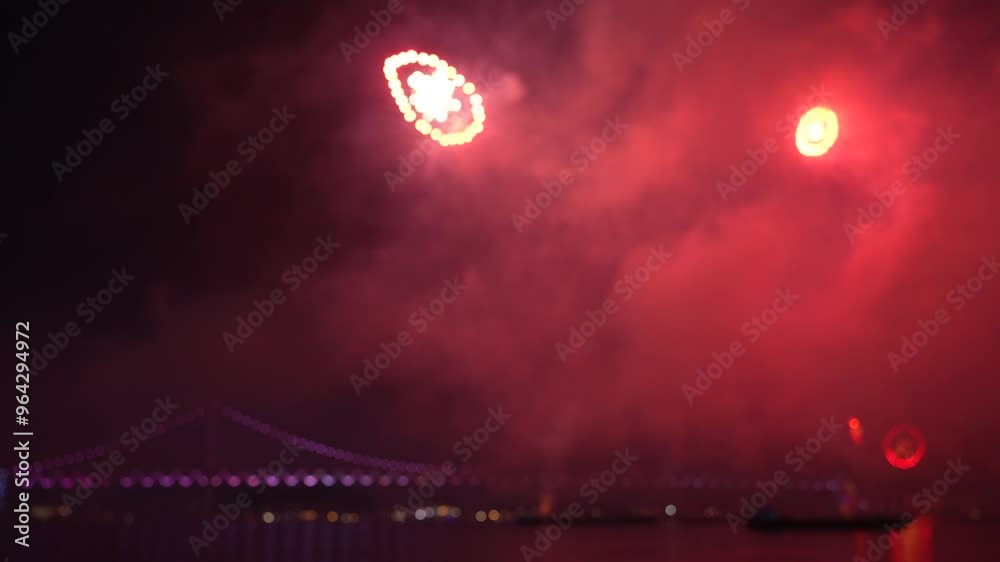 a vibrant fireworks display against a night sky in Busan, Korea. The spectacle illuminates the darkness with bursts of light and color, creating a festive atmosphere. a vibrant fireworks display against a night sky in Busan, Korea. The spectacle illuminates the darkness with bursts of light and color, creating a festive atmosphere.