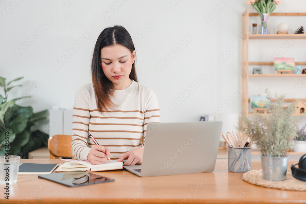 Asian businesswoman working on laptop at home office. Asian businesswoman working on laptop at home office.