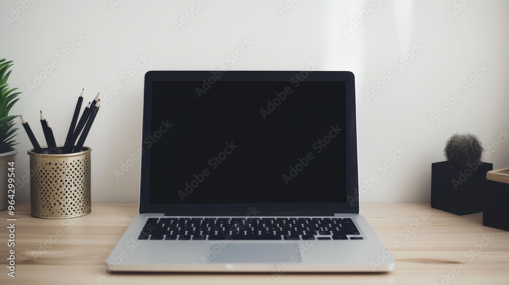 Modern workspace with a laptop on a wooden desk, featuring stationery and a small potted cactus for a minimalist and productive setting. Modern workspace with a laptop on a wooden desk, featuring stationery and a small potted cactus for a minimalist and productive setting.