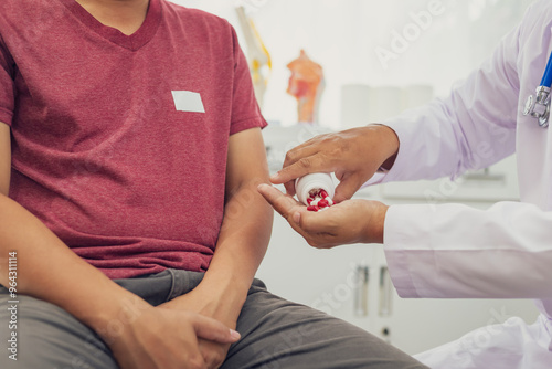 A male doctor examines a patient for an enlarged prostate, a common issue in male sexual health. This condition can cause urinary problems and is often associated with age-related changes in men. photo