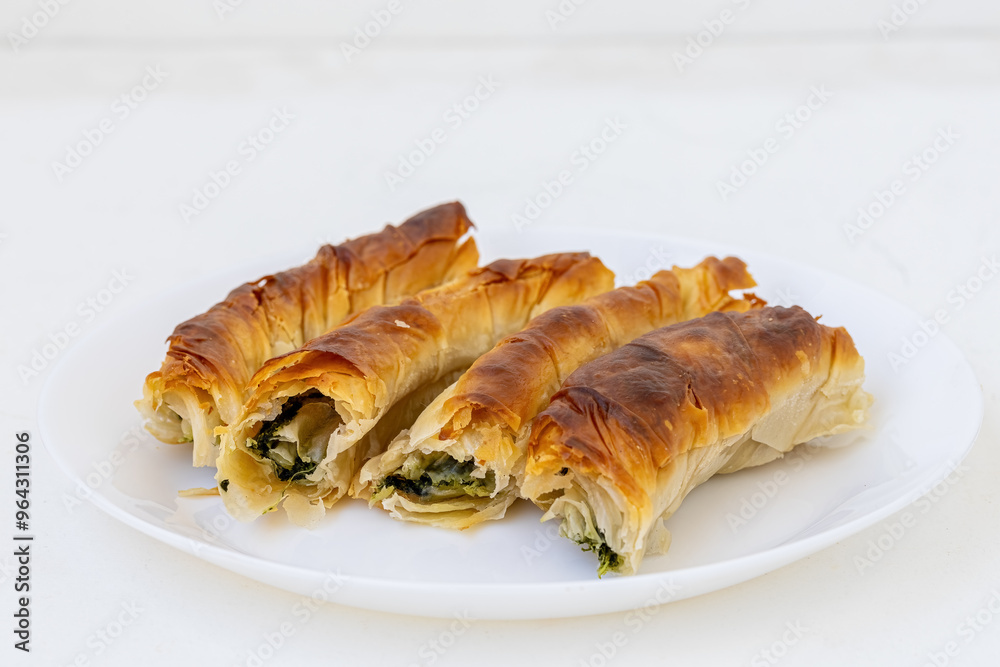 Spinach roll pastry in a white plate