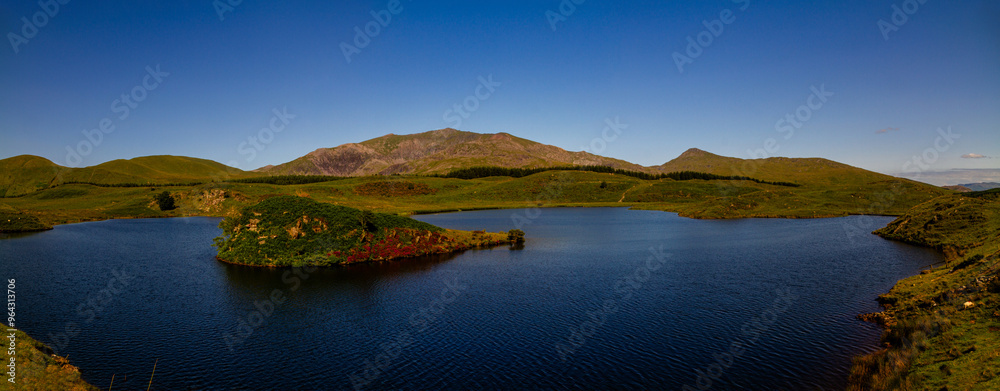 Snowdon or Yr Wyddfa mountain summit, Snowdonia or Eryri National Park lake and island in foreground Panoramic. Snowdon or Yr Wyddfa mountain summit, Snowdonia or Eryri National Park lake and island in foreground Panoramic.
