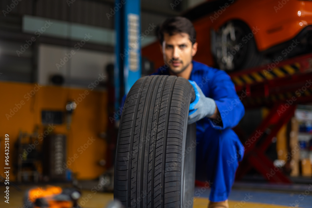 Close up tyre. Mechanic man holding tire. Car maintenance and auto service garage concept Close up tyre. Mechanic man holding tire. Car maintenance and auto service garage concept