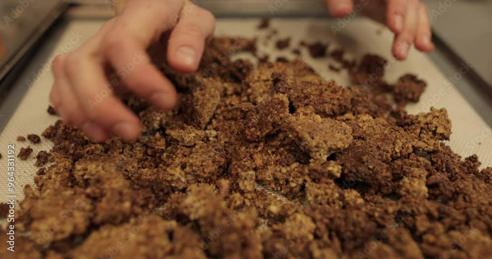 The confectioner's hands break and grind the cake into crumbs for further preparation of cakes and desserts