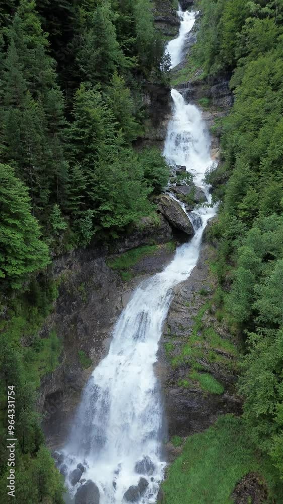 Waterfall in the Pyrenees forest background aerial view vertical shot Waterfall in the Pyrenees forest background aerial view vertical shot