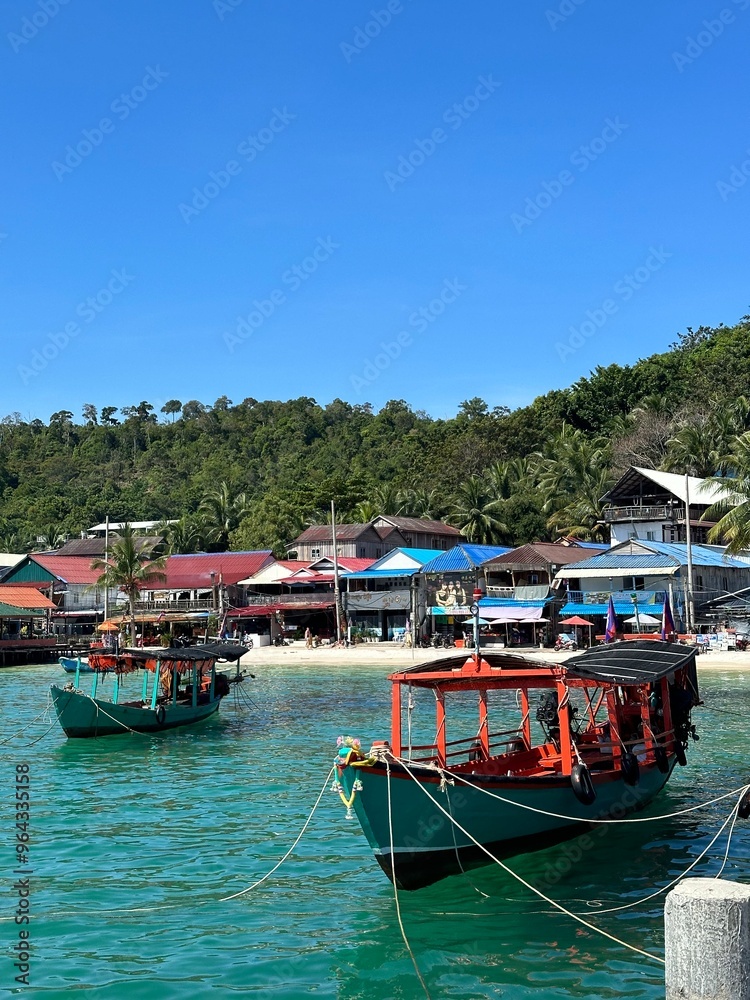 Asian boats at beautiful beach in Cambodia, island Koh Rong, red boat blue sea, white beaches and beach houses Asian boats at beautiful beach in Cambodia, island Koh Rong, red boat blue sea, white beaches and beach houses