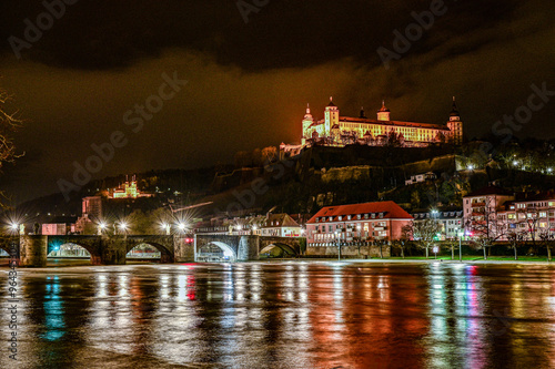 Würzburg beleuchtet bei Nacht - Festung Marienberg beleuchtet bei Nacht mit der alten Mainbrücke über den Main mit Wasserspiegelung, Würzburg Franken, Bayern, Deutschland photo