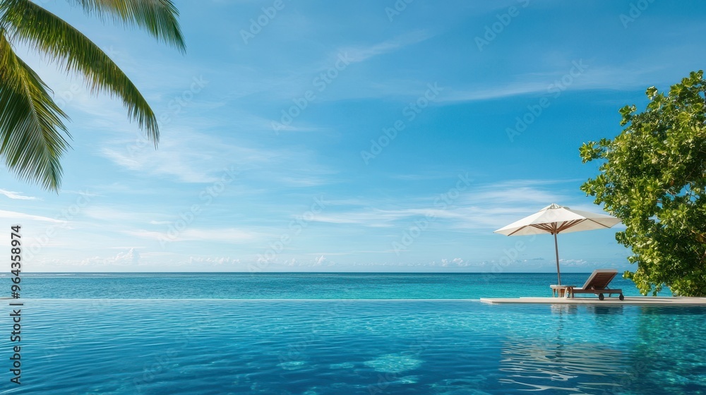 Luxurious Infinity Pool Overlooking Tropical Beach at Sunset Luxurious Infinity Pool Overlooking Tropical Beach at Sunset