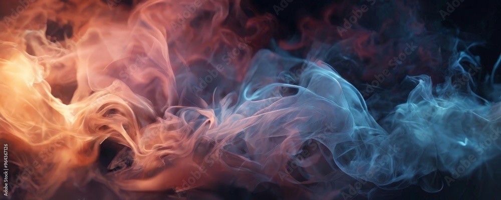 Fototapeta premium swirling smoke in shades of orange, pink, and blue, creating a dynamic and visual effect.