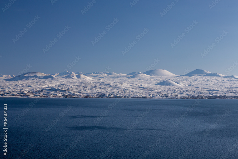 snow capped mountains on lake sevan in clear weather at sunset snow capped mountains on lake sevan in clear weather at sunset