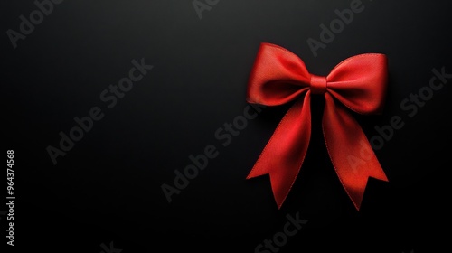 Elegant Red Bow on Black Background, a striking visual centerpiece that enhances promotional messages while exuding sophistication and festive charm.