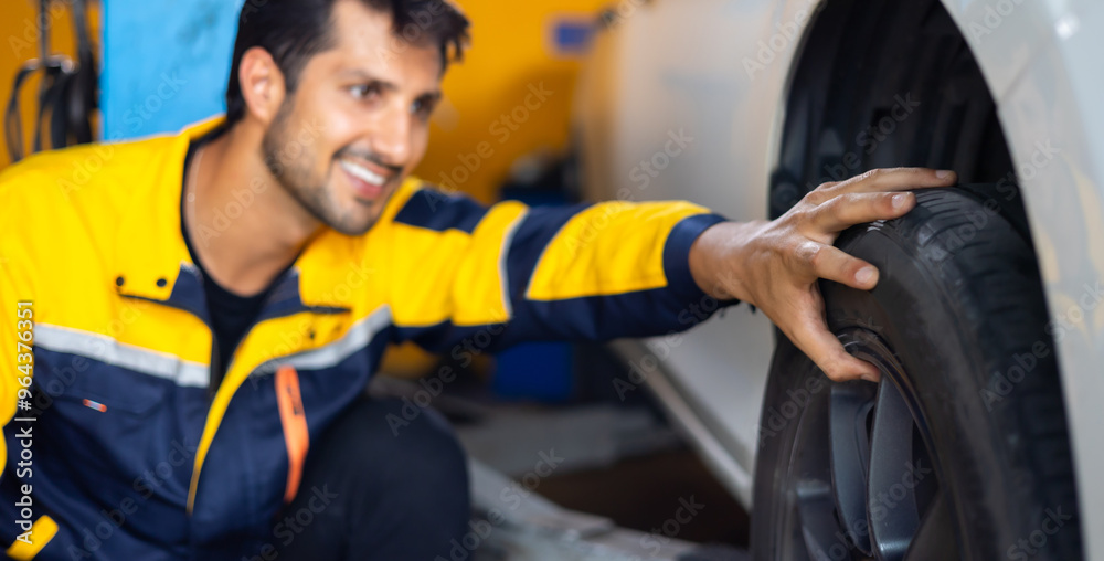 Mechanic checking checking the depth of car tire tread. Car maintenance and auto service garage Mechanic checking checking the depth of car tire tread. Car maintenance and auto service garage