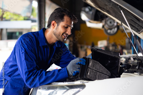 Mechanic hands chang dusty and dirty air filter pad. hispanic latin male mechanic repairs car in garage. Car repair maintenance and auto service garage concept